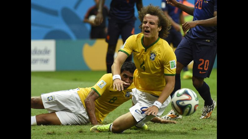 Brazil defender David Luiz, center, falls after a tackle. 