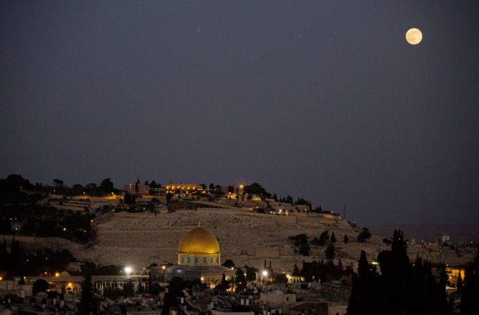 The moon over Jerusalem's Old City and the Dome of the Rock.