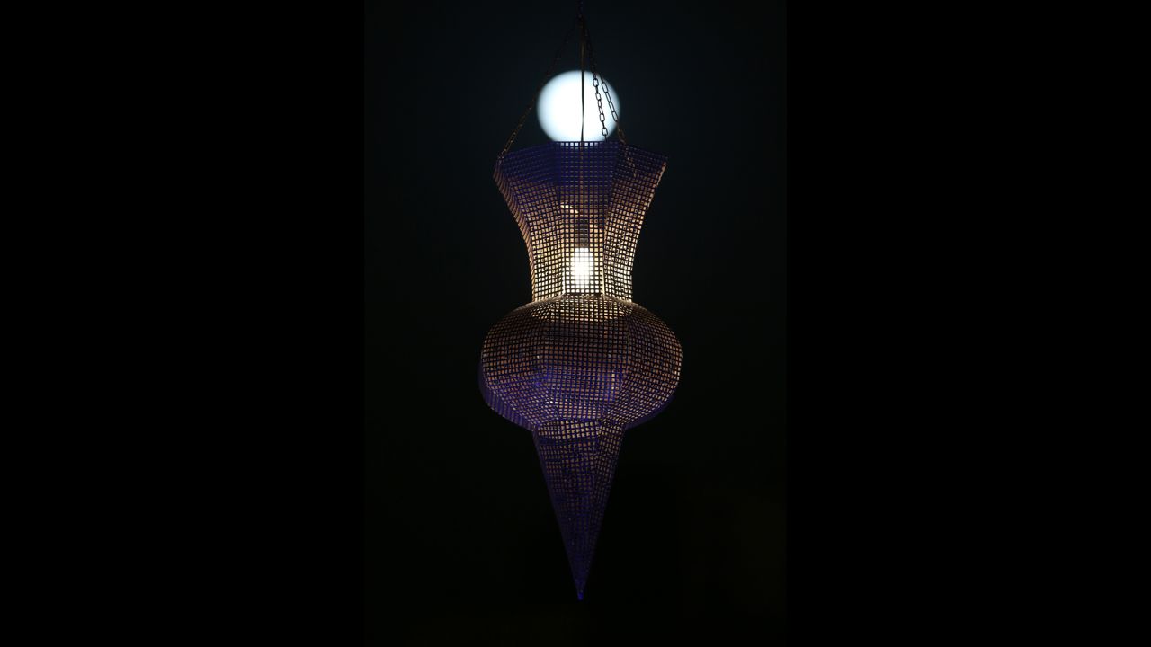 The moon is seen behind a traditional Ramadan lantern in downtown Beirut, Lebanon.