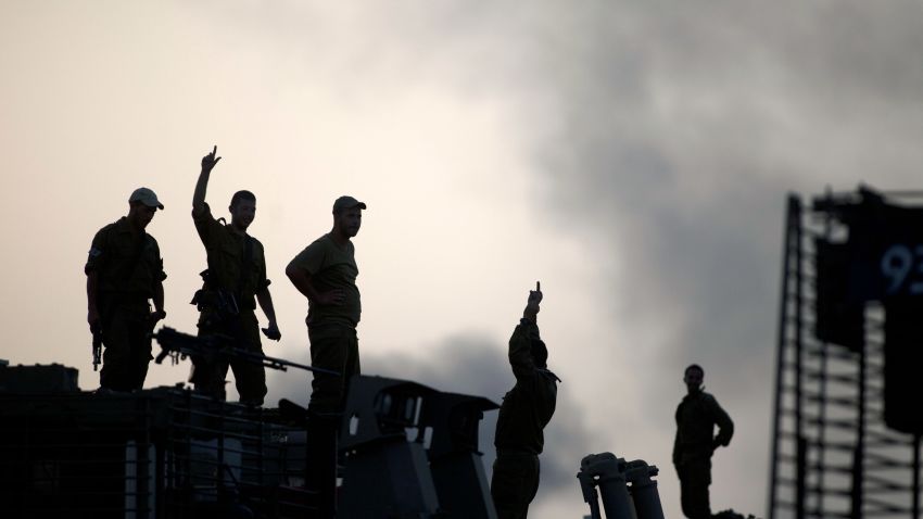  Israeli soldiers watch smoke plumes rises from Gaza following an Israel Air Force bombing on July 12, 2014 in Israel Gaza border