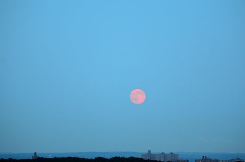 <a href="http://ireport.cnn.com/docs/DOC-1152253">Rachel Cauvin</a> photographed the supermoon hanging over the Bronx, New York, sky. The morning haze seemed to give the moon a red hue.