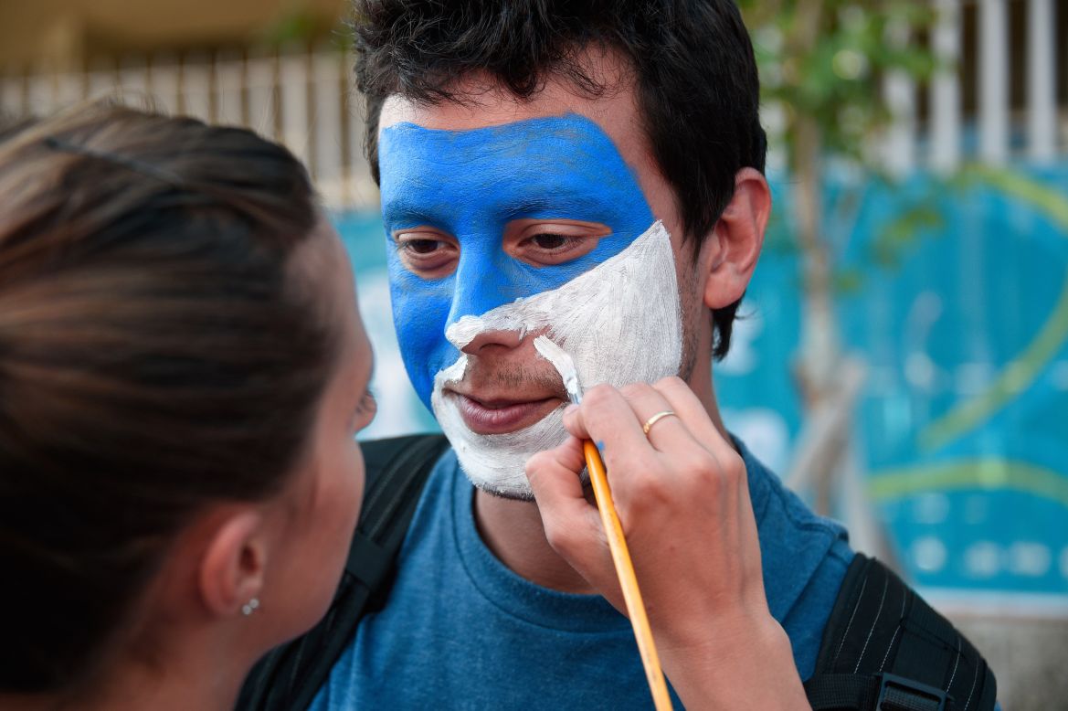 A fan has his face painted in Argentina's national colors prior to the final.