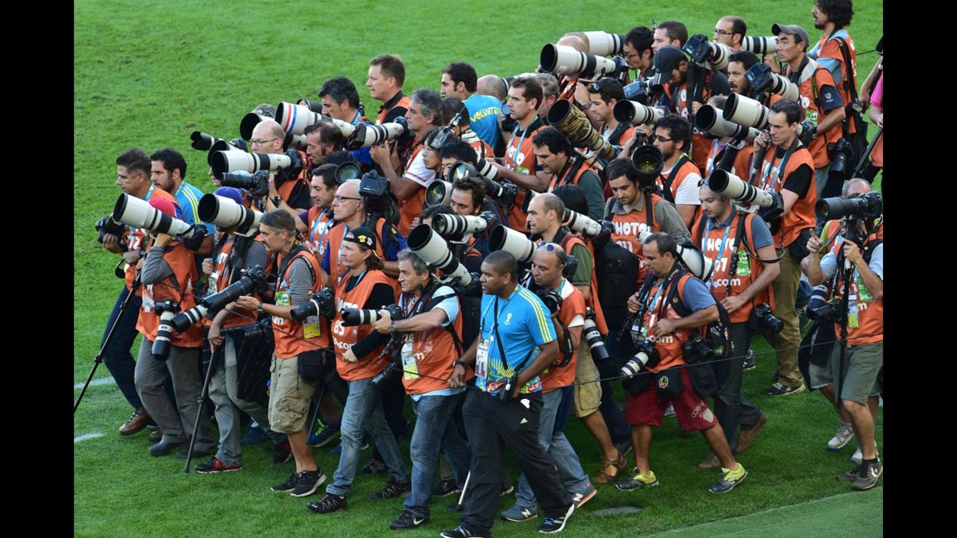 Photographers gather to take team photos before the match.