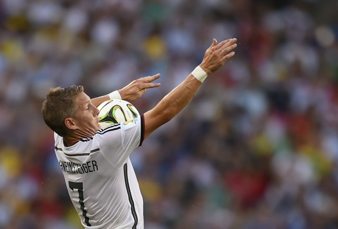 Schweinsteiger controls the ball on his chest.