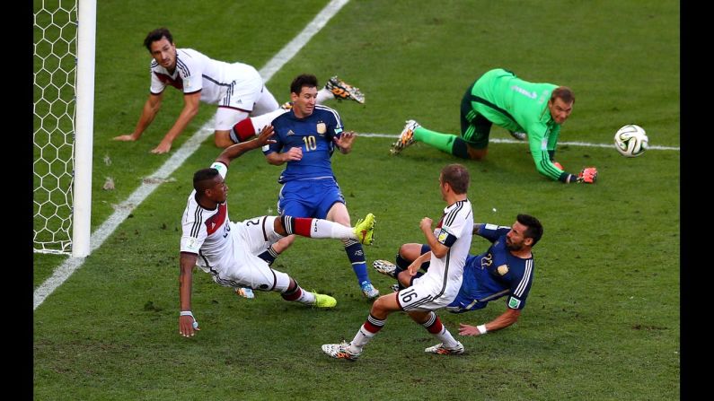 Boateng, bottom left, clears the ball as Messi and Lavezzi threaten.