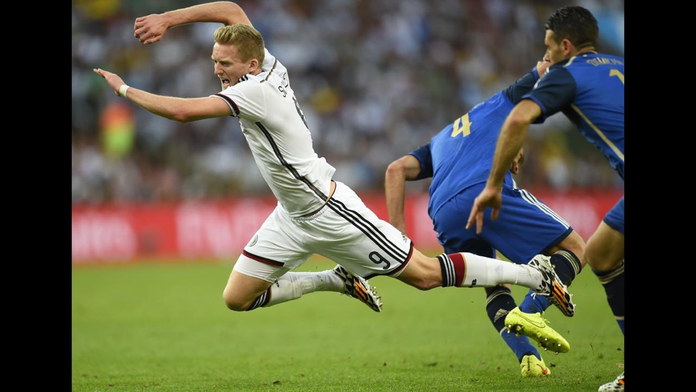 Germany's Andre Schurrle falls to the ground after a challenge from Zabaleta, center.