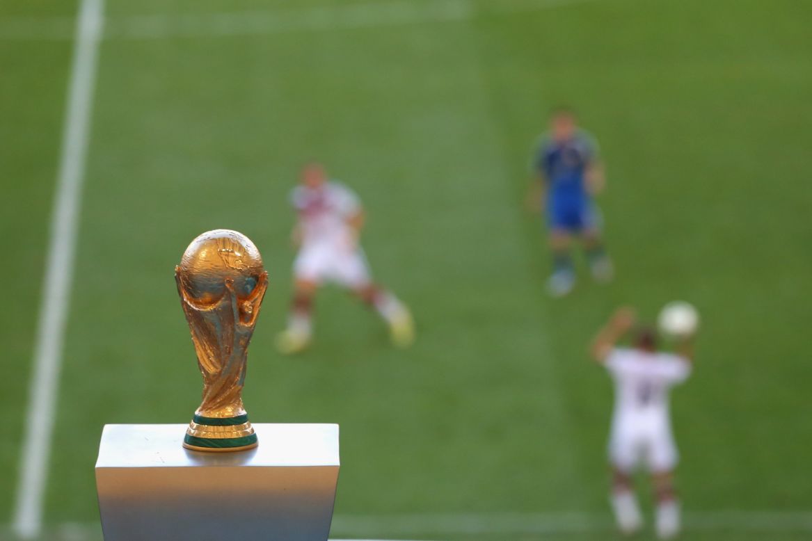 The World Cup trophy is seen in the Maracana Stadium during the match.