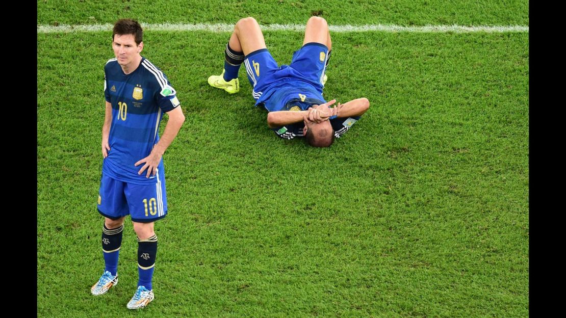 Argentina's Lionel Messi (L) and  Pablo Zabaleta react after losing the 2014 FIFA World Cup final. 