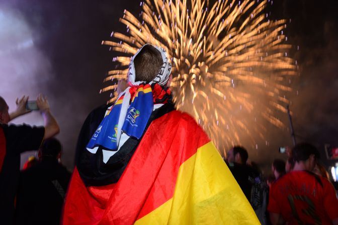 German fans watch a fireworks show near the Brandenburg Gate in Berlin.