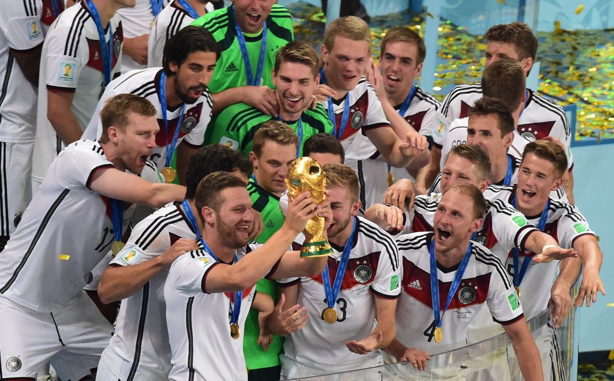German players celebrate with the World Cup trophy after they defeated Argentina 1-0 in the tournament's final match Sunday, July 13, in Rio de Janeiro. Mario Gotze's goal in extra time was the difference.