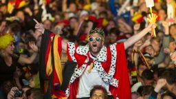 German soccer fans react after the deciding goal  for Germany in the final of  the Brazil World Cup 2014 between Germany and Argentina played  in Rio de Janeiro, Brazil, at a public viewing  area  called 'Fan Mile' in Berlin, Sunday, July 13, 2014.  Germay won by 1-0.  (AP Photo/Steffi Loos)