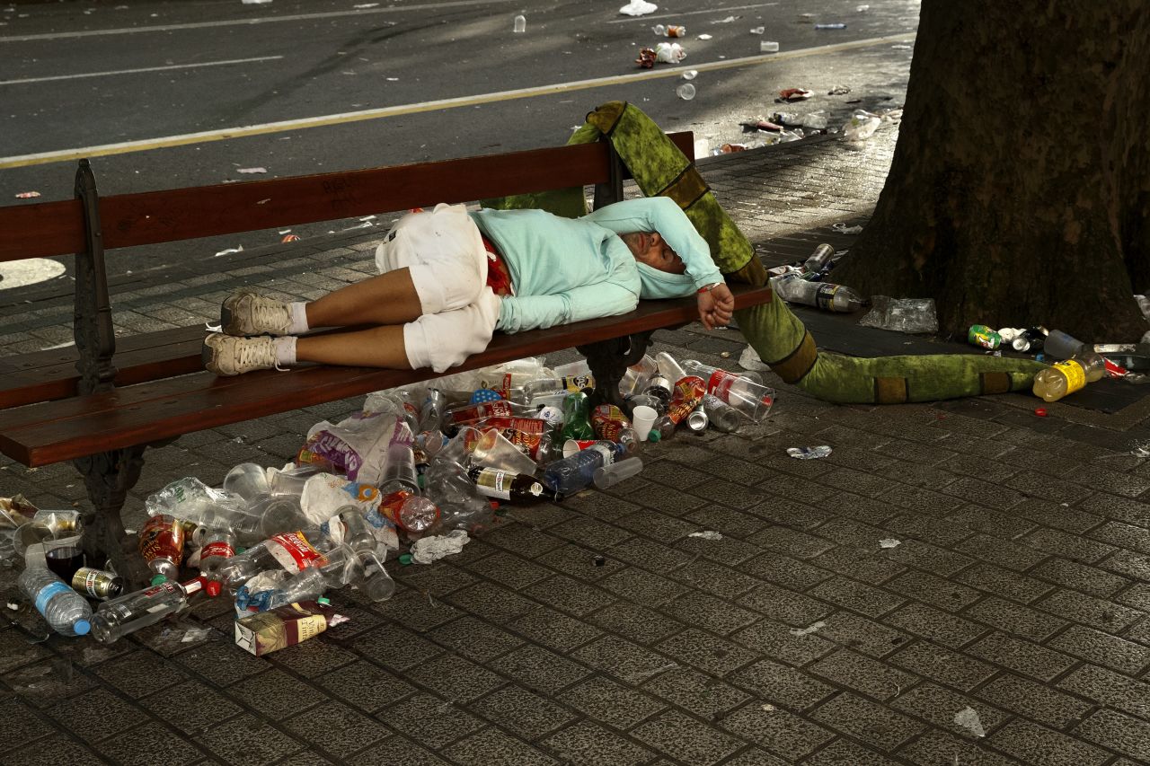A reveler sleeps on a public bench on July 13.