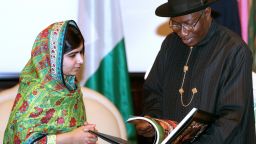 Pakistani education activist Malala Yousafzai (L) watches on July 14, 2014 Nigerian President Goodluck Jonathan look at a book at the State House in Abuja. Malala on July 14 urged Jonathan to meet with parents of the schoolgirls kidnapped three months ago by Boko Haram. Malala, who survived a Taliban assassination attempt in 2012 and has become a champion for access to schooling, was in Abuja on her 17th birthday to mark the somber anniversary of Boko Haram's April 14 abduction of 276 girls from a secondary school in the northeast Nigerian city of Chibok. 
AFP PHOTO / WOLE EMMANUELWOLE EMMANUEL/AFP/Getty Images
