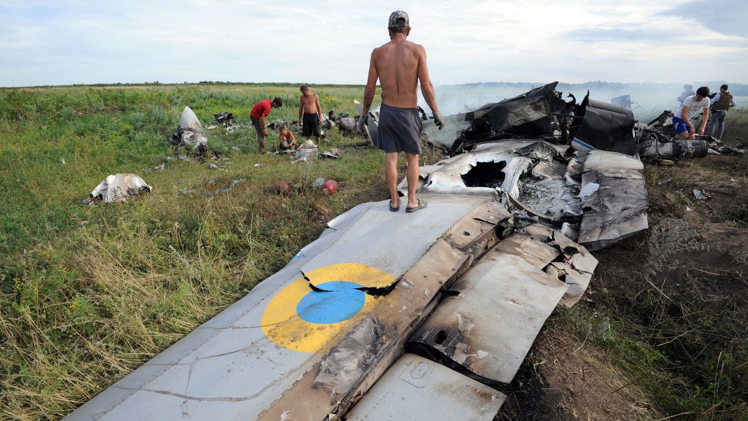 Villagers inspect wreckage of a Ukrainian transport plane Monday after it was shot down near the Russian border. 