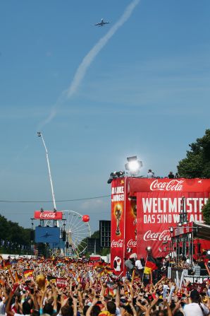 Flying in for a heroes' welcome on Tuesday, the plane carrying Germany's World Cup winners glides over the Brandenburg Gate in Berlin where fans gathered to celebrate their Brazilian success.