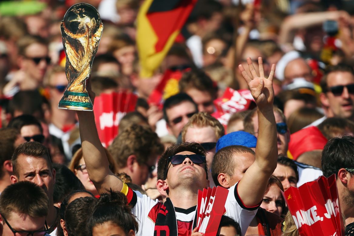 Lukas Podolski of Germany celebrates with the trophy following the