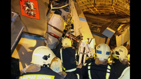 Rescuers work at the site of the accident on July 15. The rescue operation had become a recovery operation by the afternoon as emergency workers sought to free the remaining bodies from within the mangled train cars.