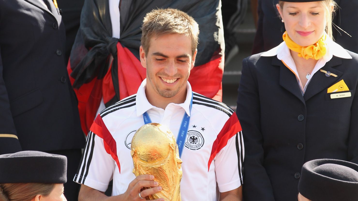 Philipp Lahm holds the World Cup as the German national team return to Berlin Tegel Airport.
