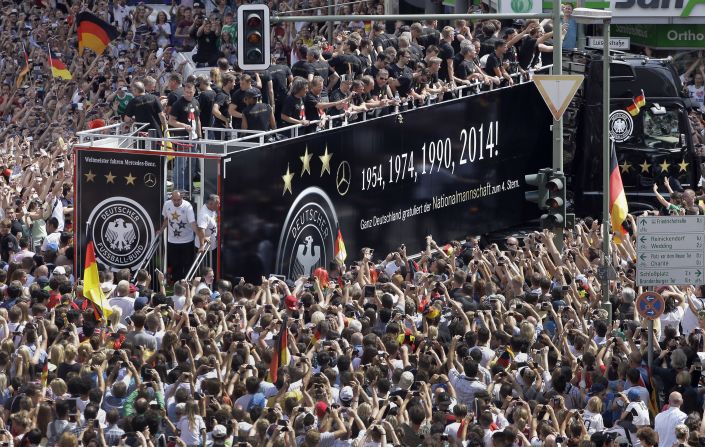 The streets of Berlin turn black, red and gold as thousands of fans welcome the squad.