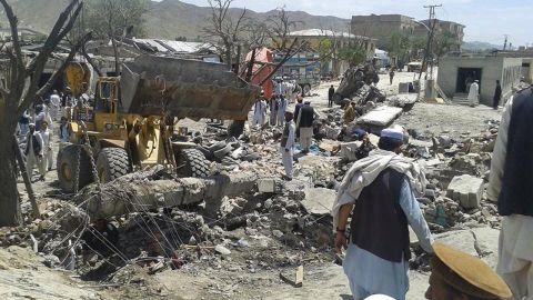 Afghans remove debris after a suicide attack at a market in Afghanistan's Paktika province in July 2014. 