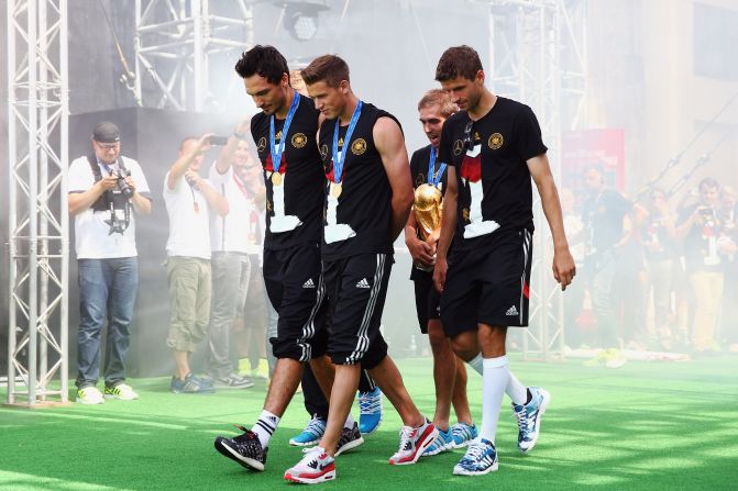 Mats Hummels, Erik Durm, Philipp Lahm and Thomas Mueller bring football's biggest prize onto the stage.