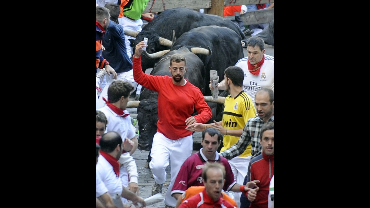 A man takes a selfie Friday, July 11, as he participates in the annual <a href="http://www.cnn.com/2014/07/07/world/gallery/running-of-the-bulls/index.html">running of the bulls</a> in Pamplona, Spain. The bull run, a 400-year tradition, is part of the San Fermin festival. But according to the city's new rules, carrying any device to record video or take pictures <a href="http://www.cnn.com/2014/07/14/travel/spain-pamplona-selfie/index.html">is prohibited</a> because it could distract the runner and endanger others.