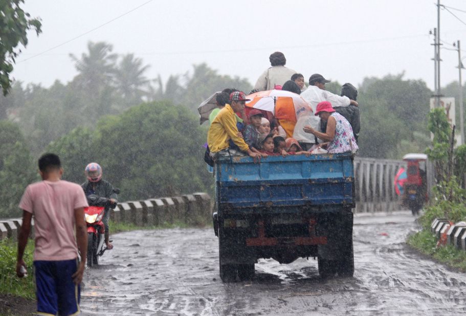 Residents ride on a truck as they are evacuated from the approaching Typhoon Rammasun in Legazpi City, southeast of Manila, on July 15. 