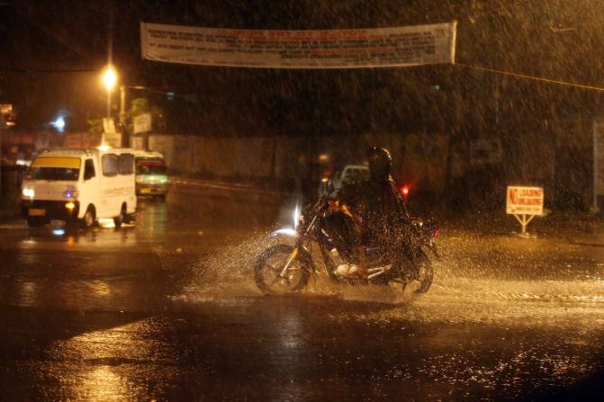 Motorists pass by on a highway during a heavy rain storm on July 15 in Cotabato, Mindanao, Philippines. 