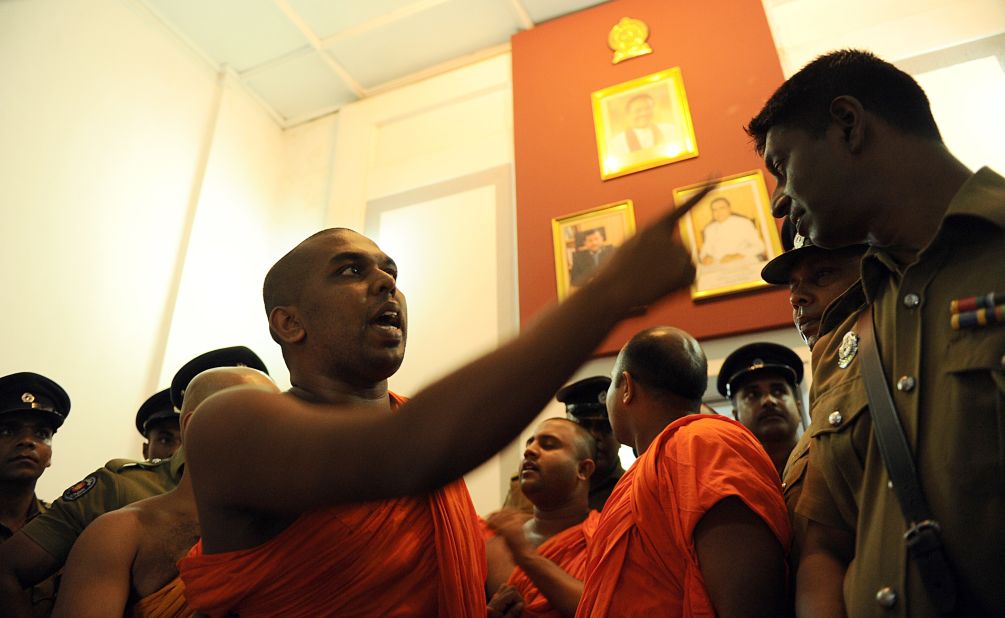 A monk belonging to the group debates with a police officer at the Trade Ministry in Colombo in April.