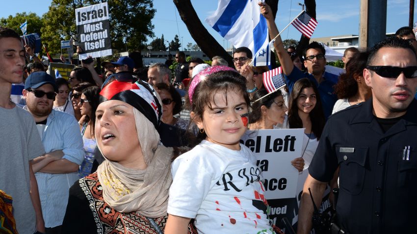 Image #: 30803590    A Palestinian woman and her daughter are escorted past Israeli American protesters during a demonstration in support of Israel in the Westwood section of Los Angeles on July 13, 2014. A Palestinian counter demonstration was held across the street to protest Israeli airstrikes on the Gaza Strip, which has reportedly killed nearly 200 Palestinians.  UPI/Jim Ruymen /LANDOV