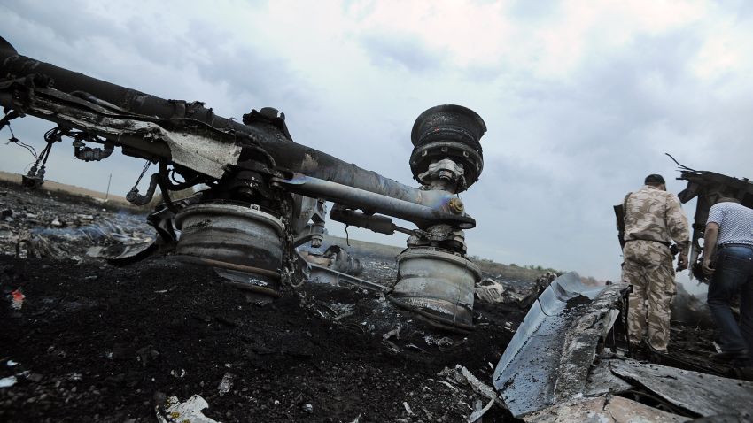 A man stands next to wreckage from Malaysia Airlines Flight 17 near Torez, Ukraine, on Thursday, July 17.