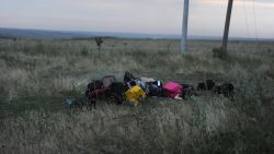 Luggage from the flight sits in a field at the crash site.