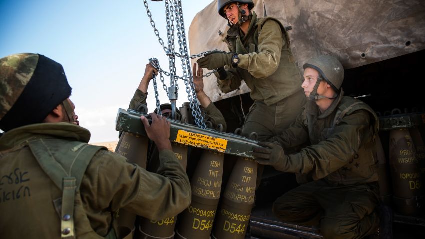  Israeli soldiers receive a new crate of artillery shells for firing into Gaza on July 17, 2014 near Sderot, Israel.