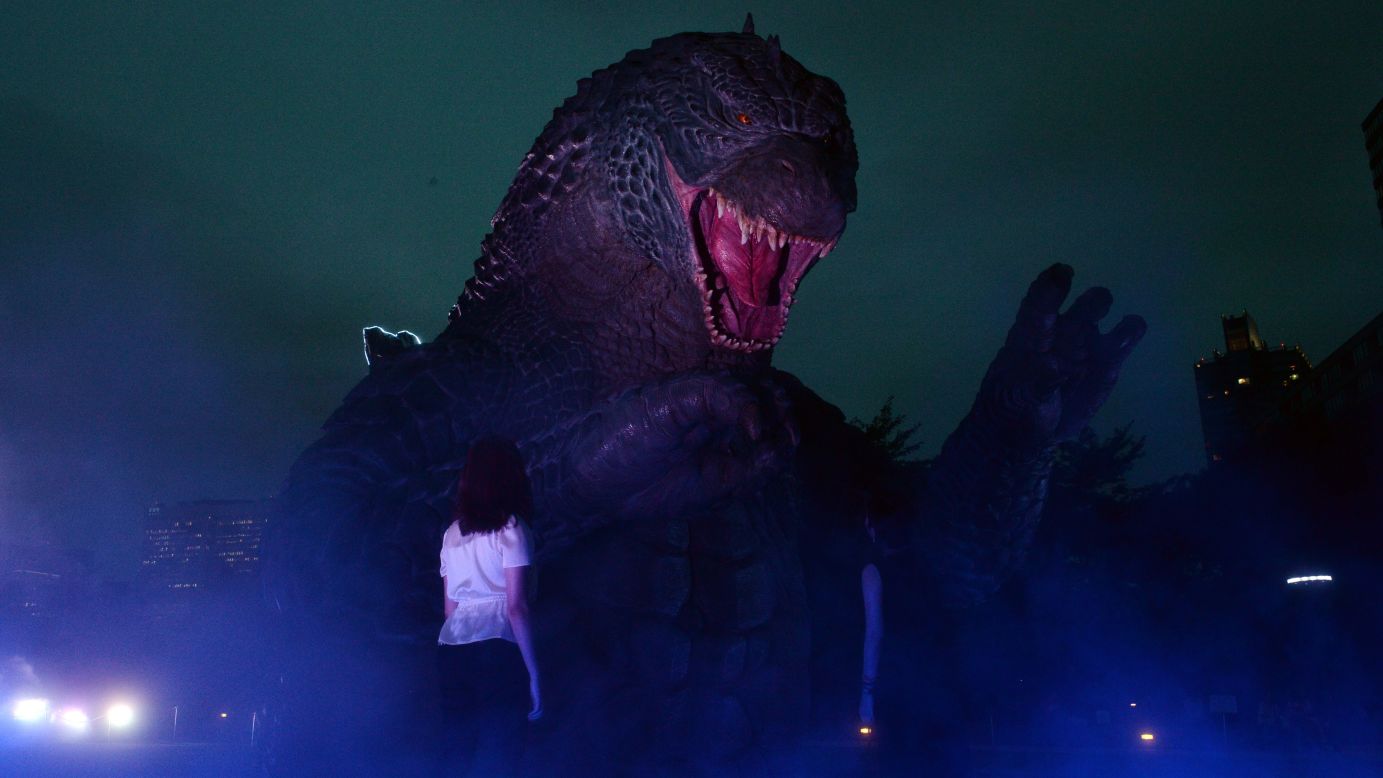 A <a href="http://www.cnn.com/2014/05/15/showbiz/gallery/tsuburaya-godzilla/index.html" target="_blank">Godzilla</a> statue is illuminated at a park in Tokyo on Thursday, July 17, to promote the recent reboot of the movie franchise.