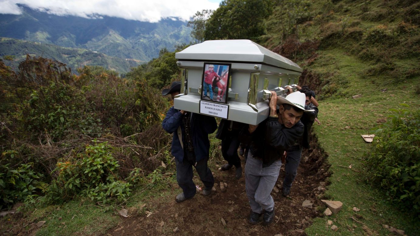 Relatives carry the coffin of 15-year-old Gilberto Francisco Ramos Juarez on Saturday, July 12, in San Jose Las Flores, Guatemala. The young Guatemalan migrant was buried in his hometown nearly a month after his decomposed body was found in the Rio Grande Valley of South Texas. 