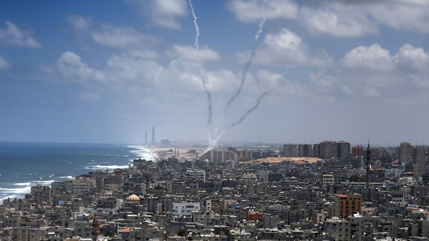 Smoke billows after rockets were launched toward Israel from Gaza City on Tuesday, July 15. People on both sides of the conflict have expressed concerns about the fate of children caught amid the Hamas rocket barrages and Israeli airstrikes.