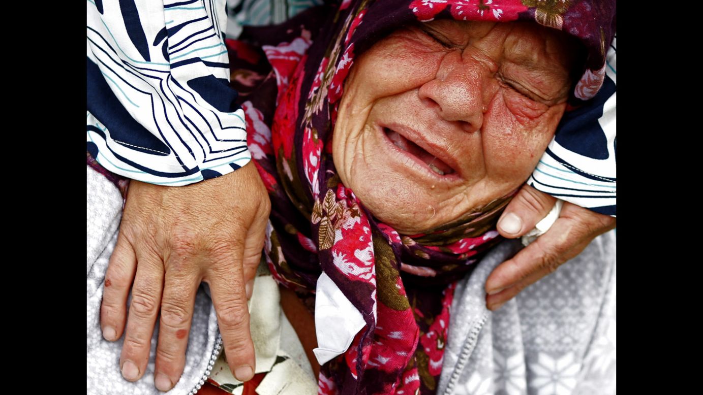 A Bosnian Muslim woman mourns while visiting the coffin of a relative at the Potocari Memorial Centre near Srebrenica on Friday, July 11. Bosnian Serb forces massacred nearly 8,000 Muslim men and boys in 1995. The remains of 175 newly identified bodies were found in dozens of mass graves.