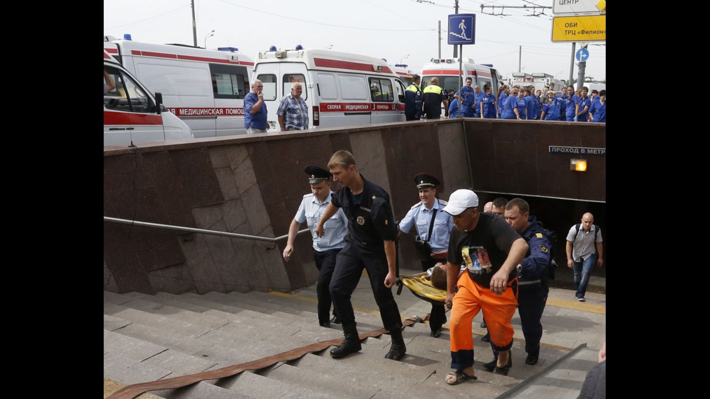 Paramedics and firefighters carry an injured man after a<a href="http://www.cnn.com/2014/07/15/world/gallery/moscow-train/index.html" target="_blank"> metro train derailed in Moscow</a> on Tuesday, July 15. It was not immediately clear what caused the derailment, which took place during morning rush hour in the Russian capital. At least 22 people were killed.