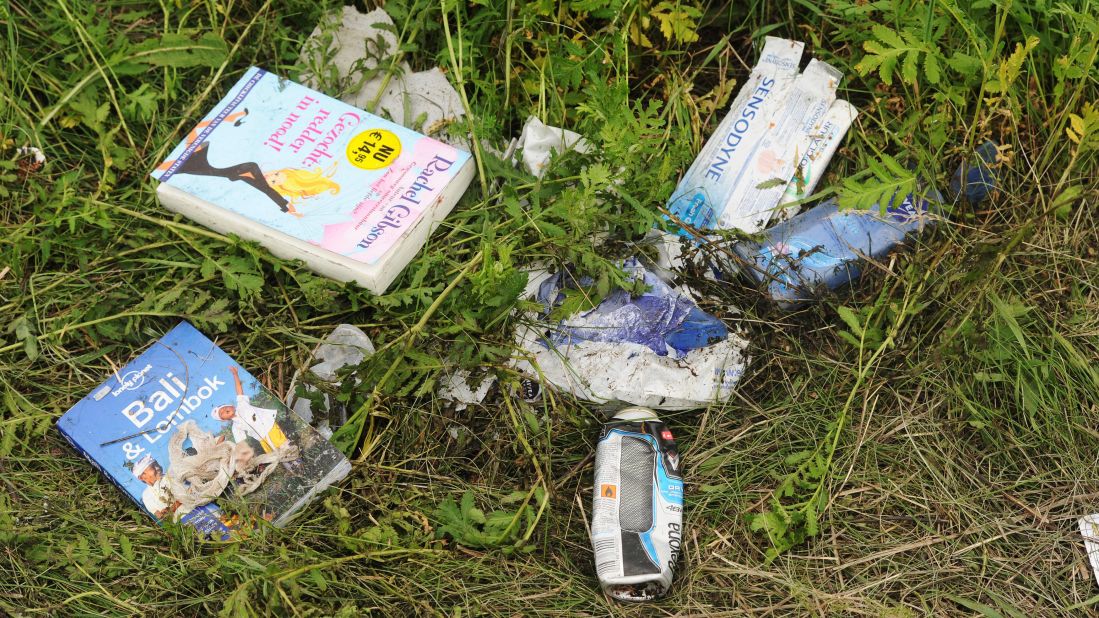 Belongings of passengers lie in the grass on July 18, 2014.