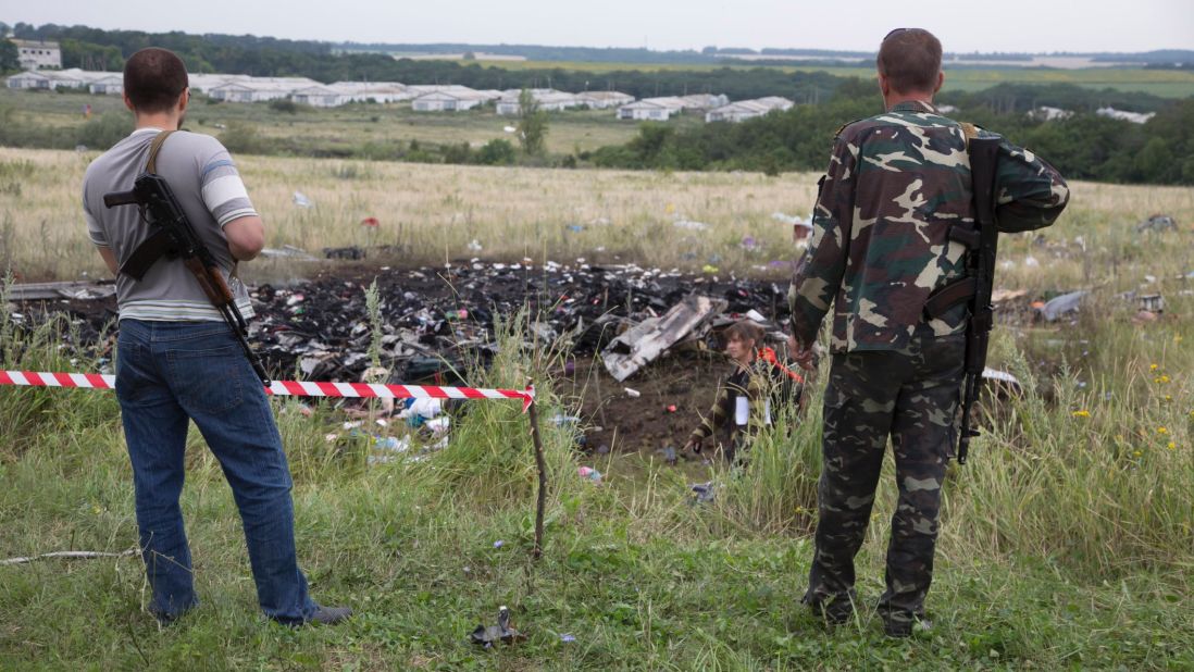 Pro-Russian rebels stand guard at the crash site.
