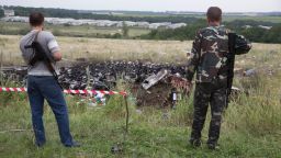 Pro-Russia separatists stand guard at the crash site of Malaysia Airlines Flight 17 in eastern Ukraine near the Russian border on Friday, July 18.