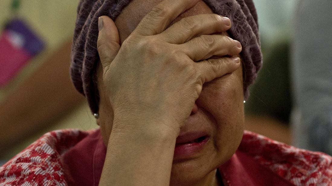 Akmar Binti Mohd Noor, whose sister was aboard Flight 17, cries outside the family holding area at Kuala Lumpur International Airport on July 18.
