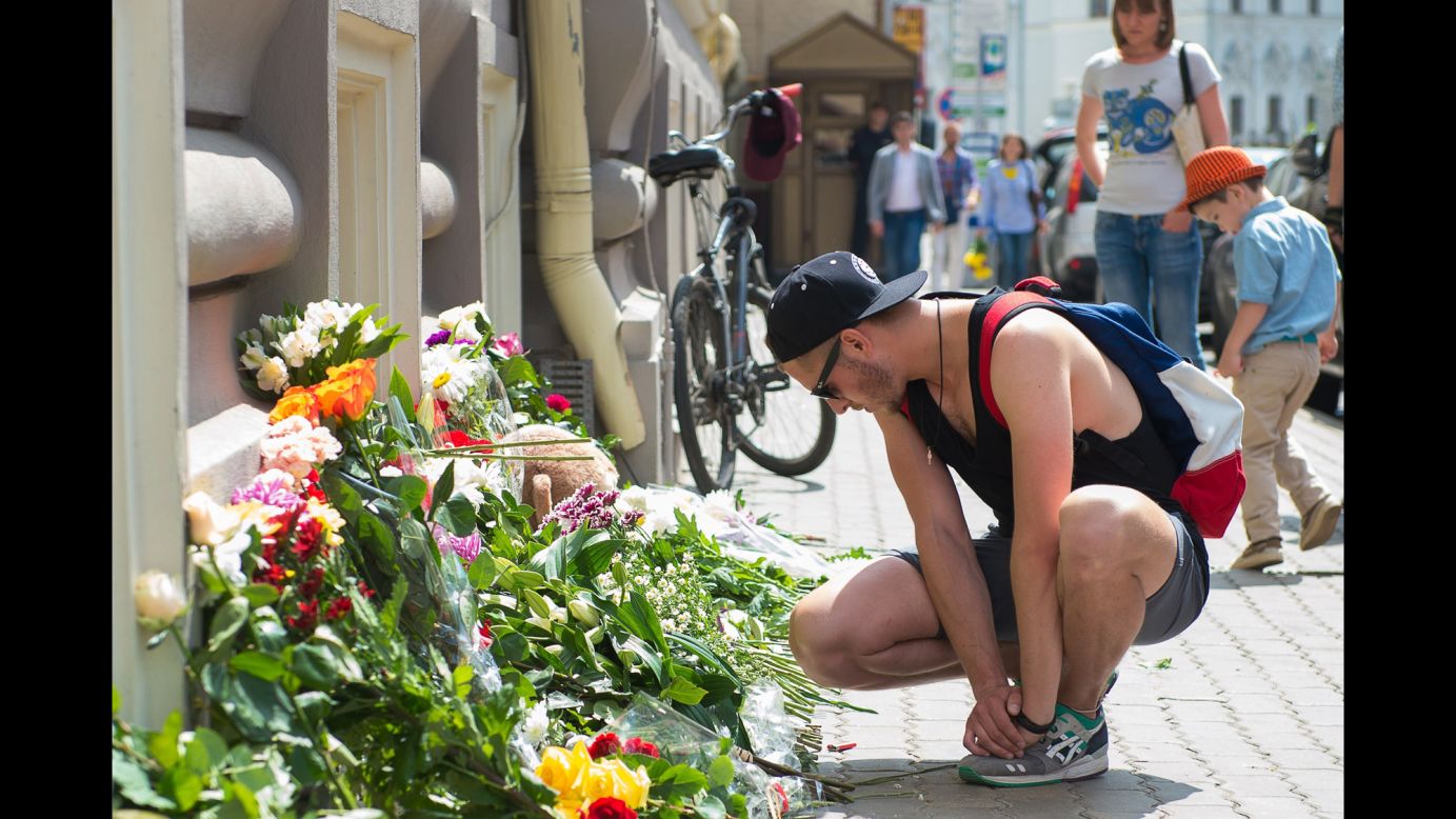 People place flowers in front of the Dutch Embassy in Moscow on July 18.