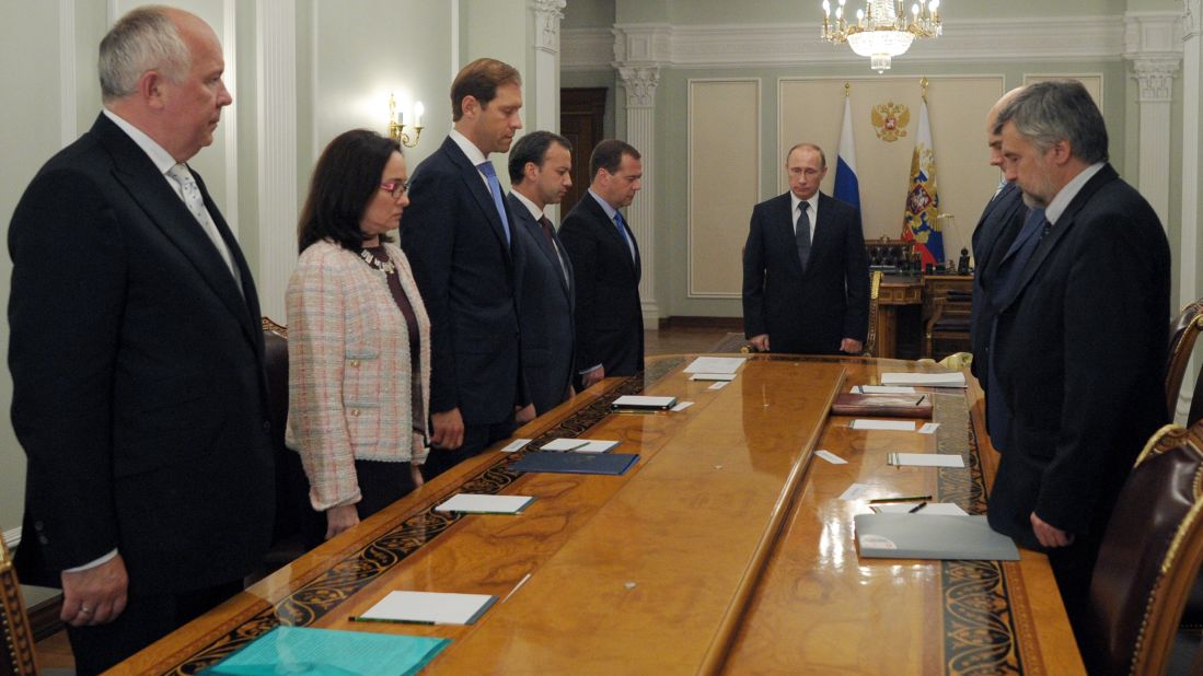 Russian President Vladimir Putin, center, and members of his government observe a moment of silence on Thursday, July 17.