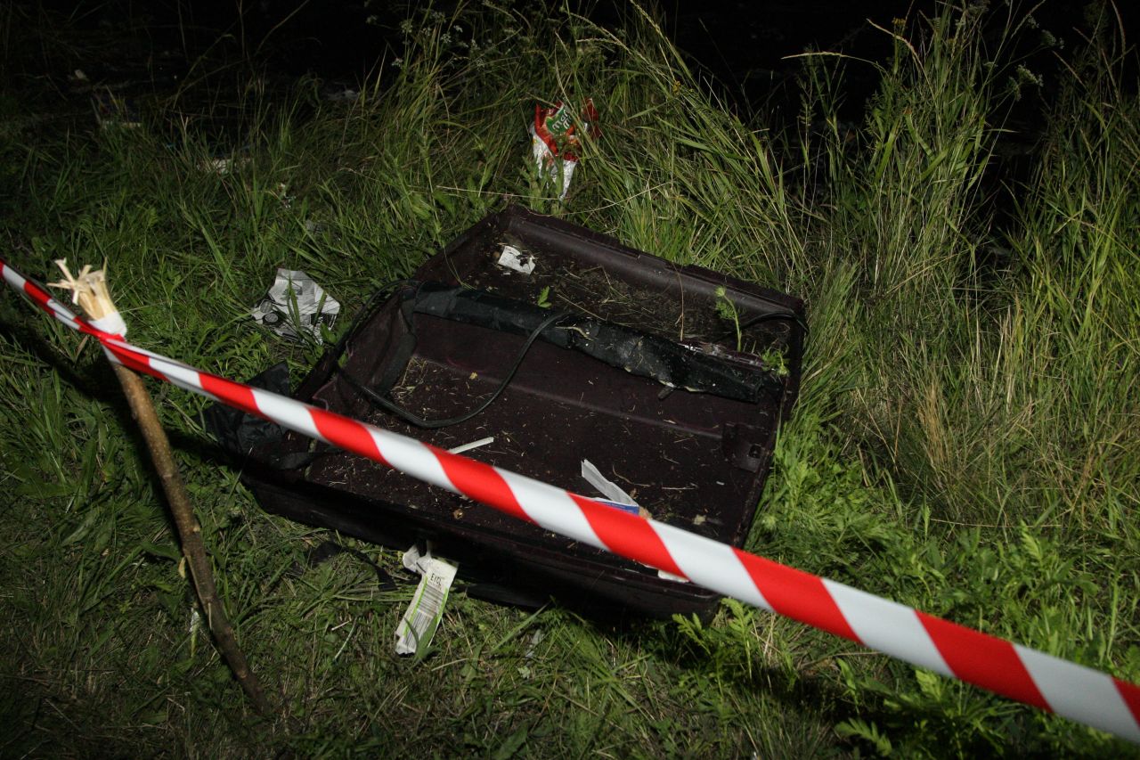 An empty suitcase is cordoned off near the plane's impact site on Thursday, July 17.