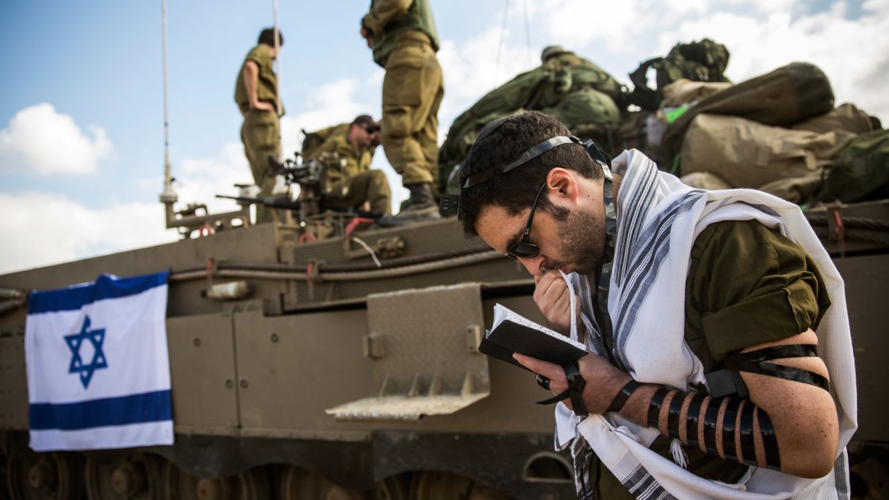 An Israeli reservist prays July 18 near the Gaza border by Sderot, Israel.