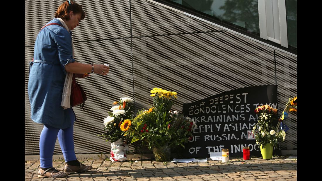 A woman in Berlin places a candle at a memorial on July 18. 