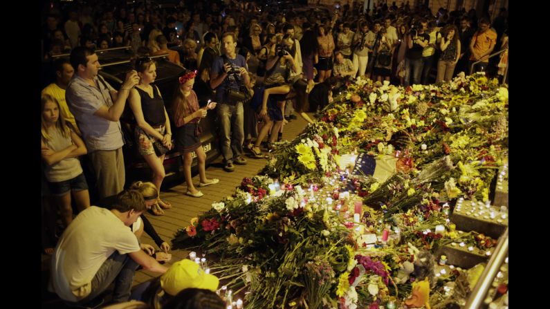 People leave flowers for the victims at the Dutch Embassy in Kiev.