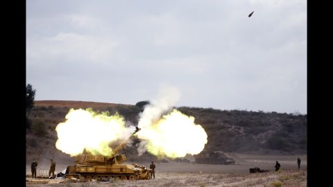 An Israeli tank fires a shell into Gaza on July 18.