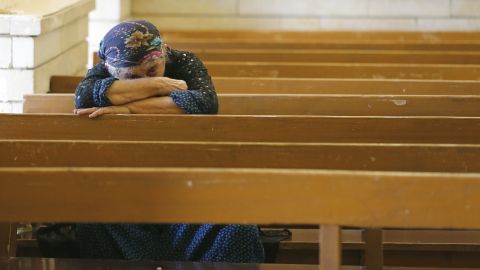 An Iraqi Christian prays at the Saint George church on July 1 in Erbil.